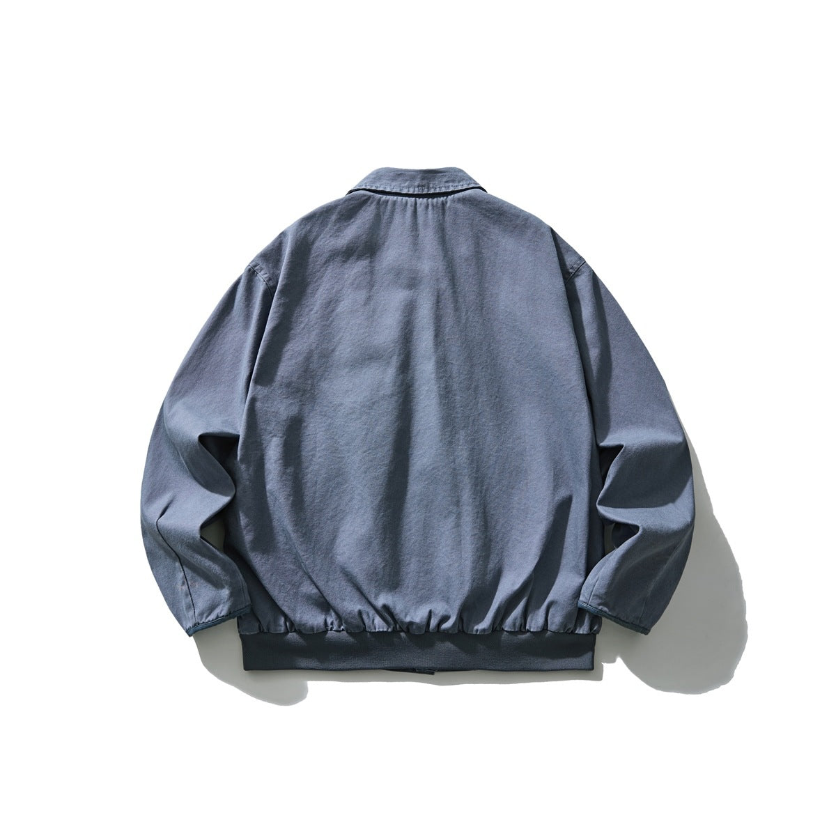 Back view of a blue collared jacket with long sleeves and a dark ribbed hem.