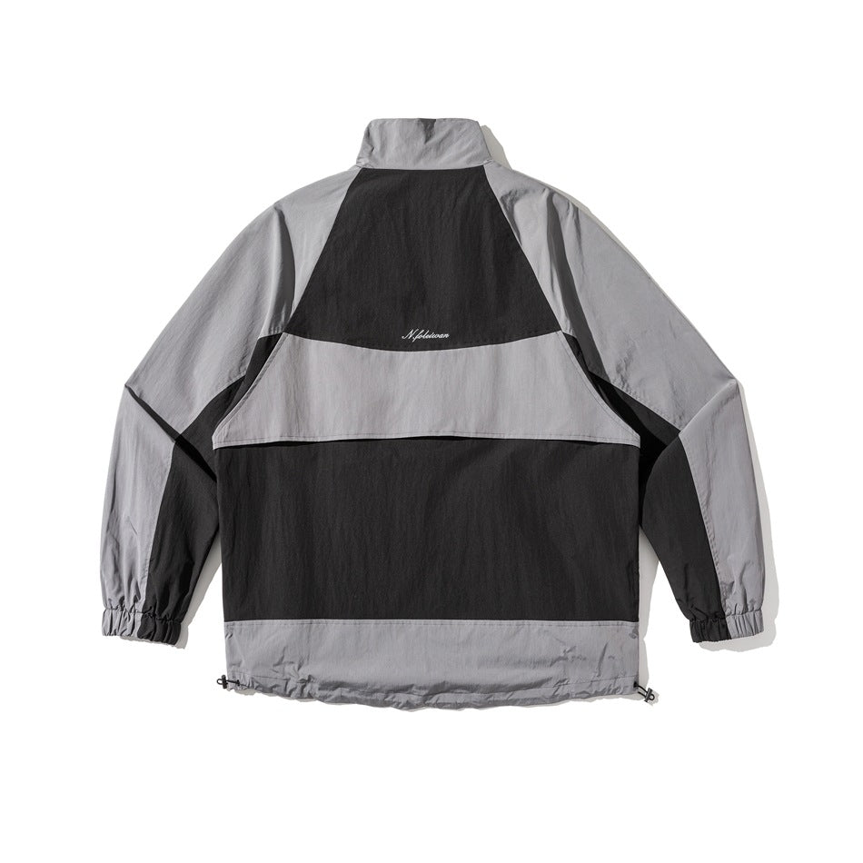 Back view of a light gray and black color-block jacket with a high collar, elastic cuffs, and adjustable hem.