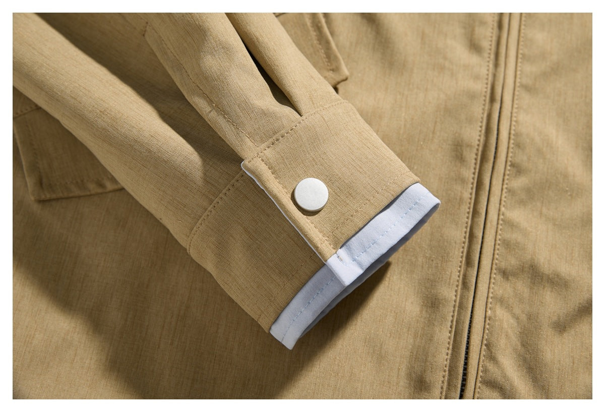 Close-up of a tan jacket sleeve cuff with a white lining edge and a round snap button.