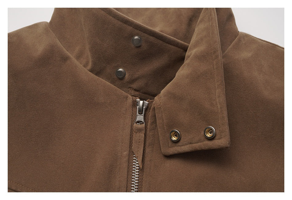 Close-up of a brown jacket’s high collar, snap fasteners, and front zipper.