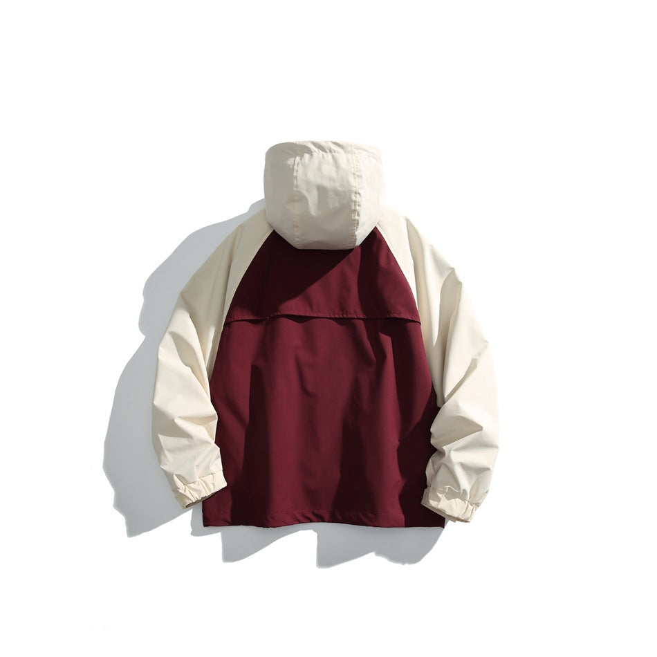 Back view of a burgundy-and-cream hooded jacket laid flat, with cream sleeves and hood.