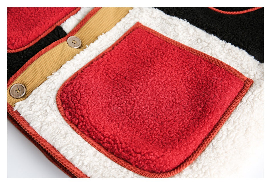 Close-up of a red patch pocket with rust piping on the white fleece panel of a color-block jacket.
