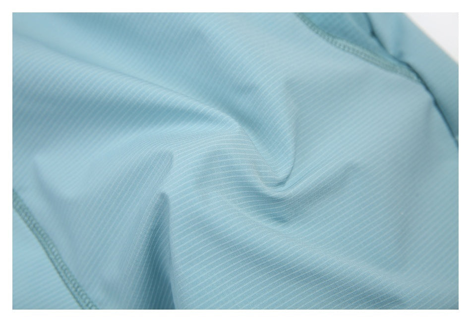 Close-up of light blue fabric with fine, subtle stripes and visible stitching.