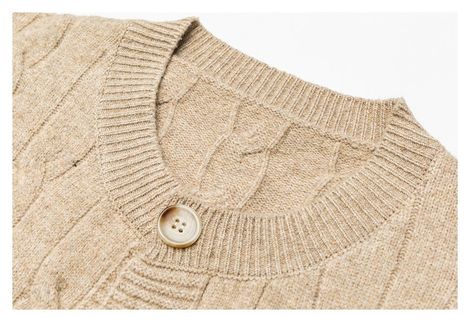 Close-up of a beige cable-knit cardigan's ribbed V-neckline and single button.