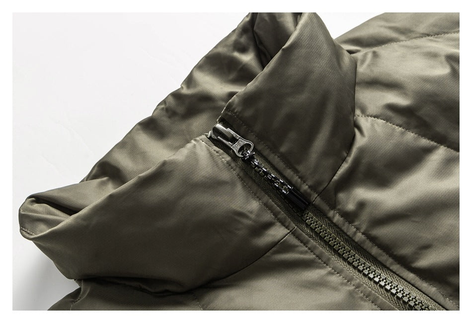 Close-up of an olive-gray jacket with a dark zipper and folded collar or hood detail.