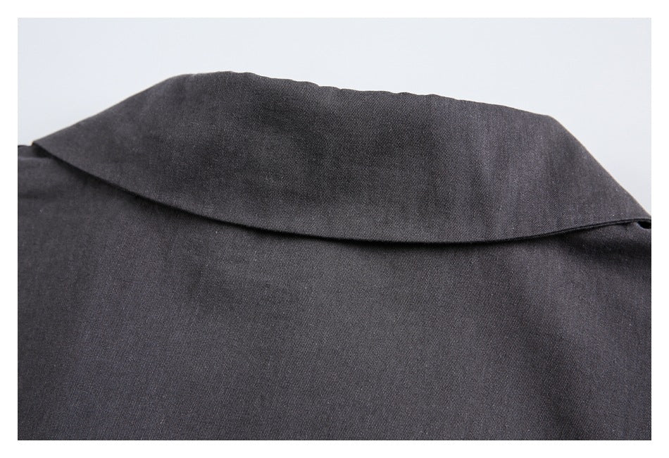 Close-up of the broad collar and upper back of a charcoal garment.