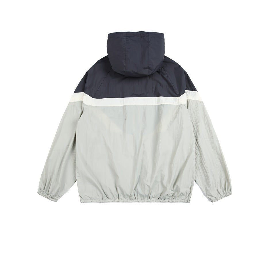 Back view of a hooded jacket with a dark navy upper panel, white stripe, and light gray body and sleeves.