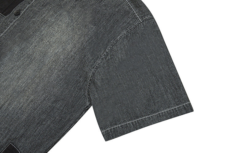 Charcoal gray shirt sleeve close-up with a curved seam and white stitching along the hem.