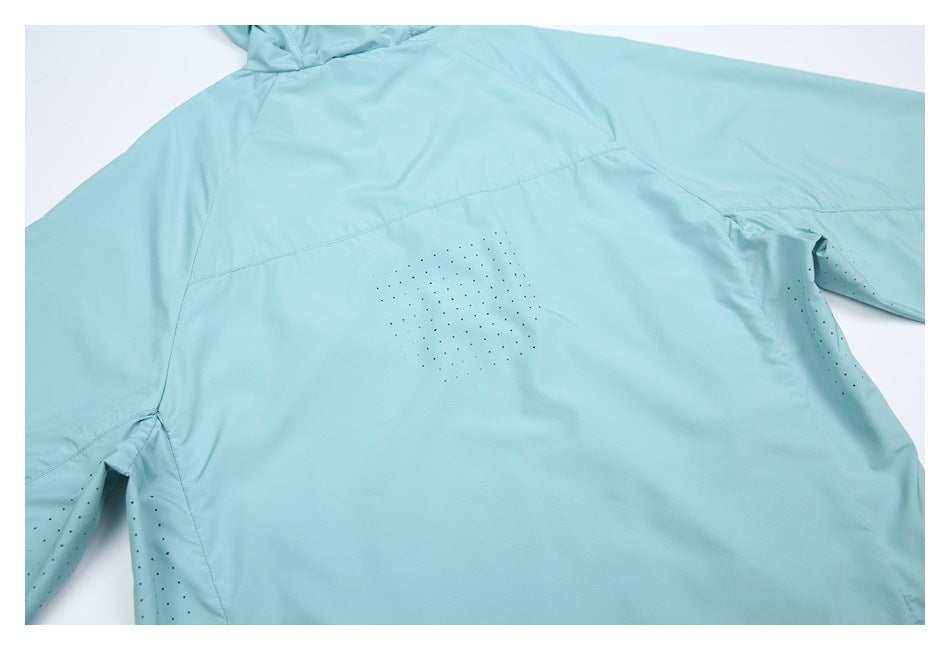 Flat-lay back view of a pale aqua long-sleeve garment with perforated ventilation panels.