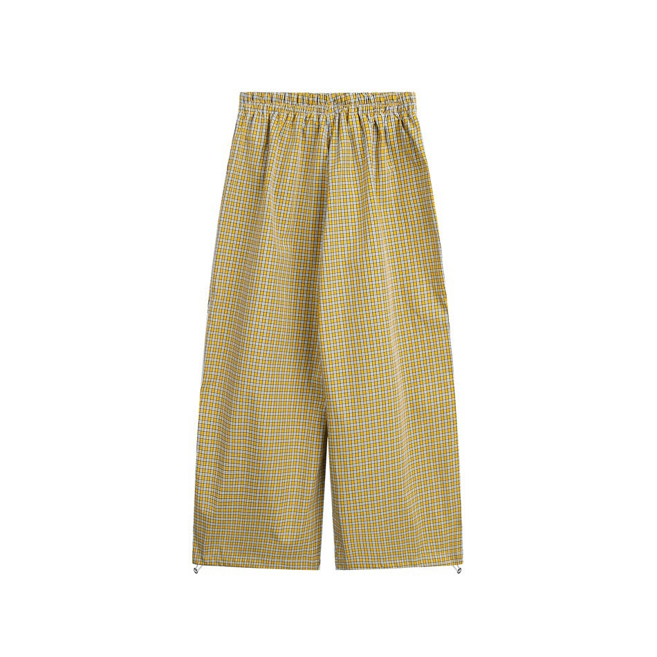 Full-length yellow-and-white checked wide-leg pants with an elastic waistband, shown flat against a white background.