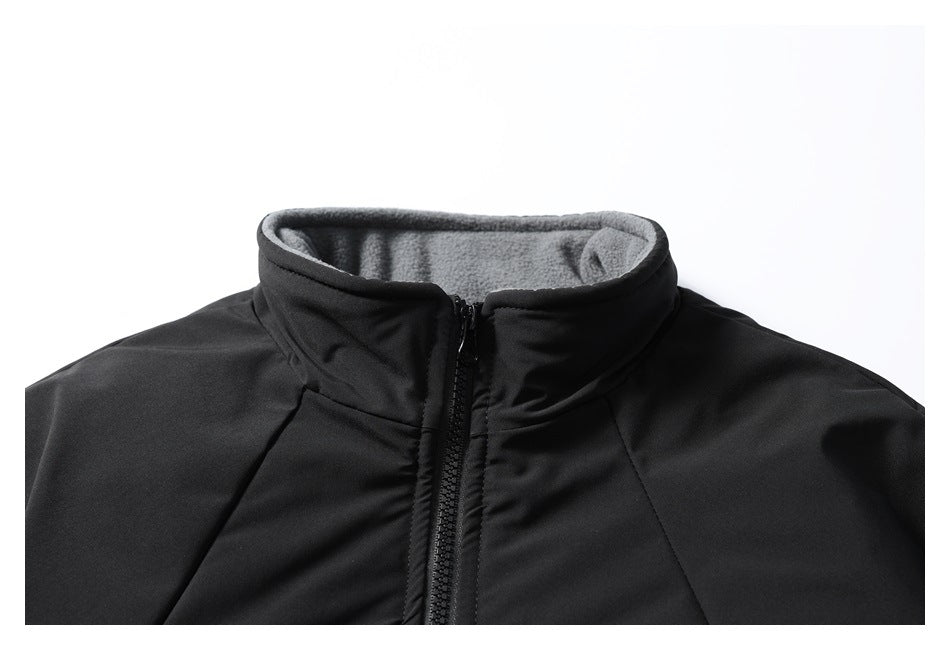 Close-up of a black jacket's stand collar, gray inner lining, and center zipper.