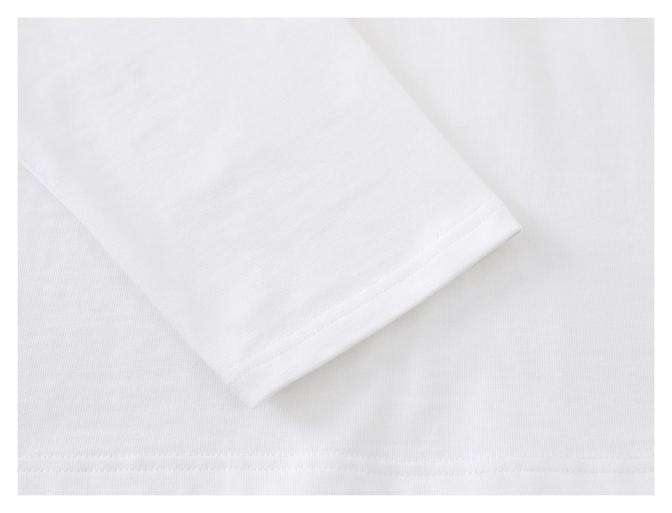 Close-up of a white T-shirt sleeve and stitched hem.