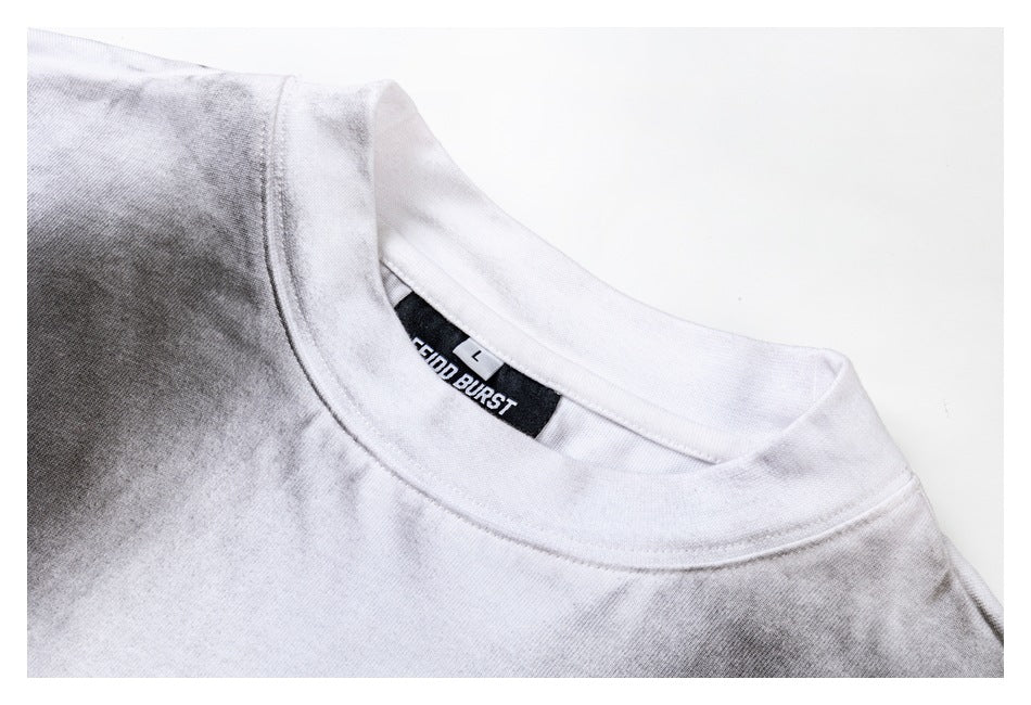 Close-up of the white shirt's crew neckline, shoulder seam, and black neck label.