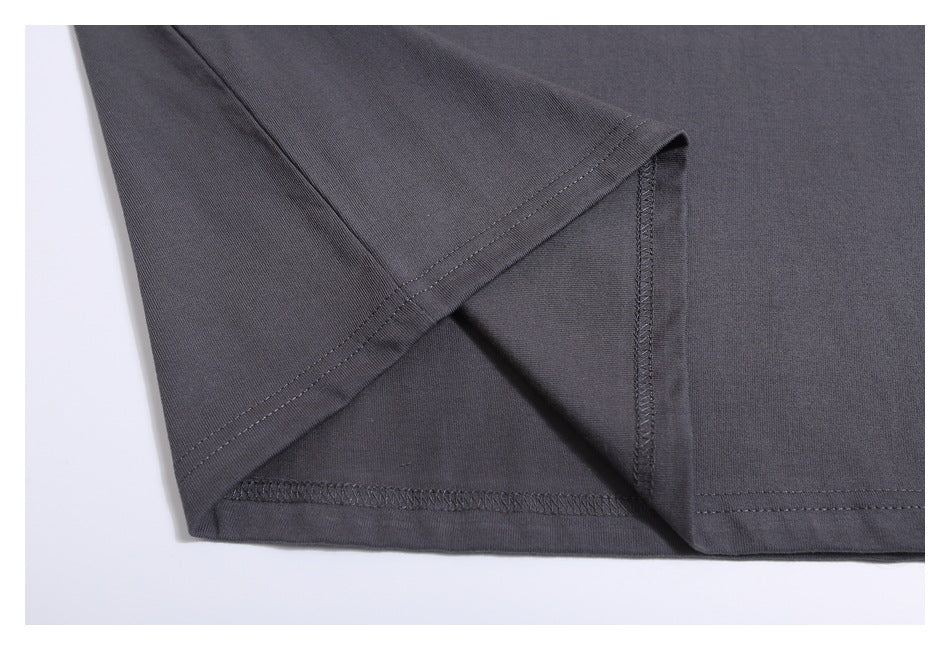 Close-up of the charcoal gray T-shirt sleeve and side seam with visible stitching.