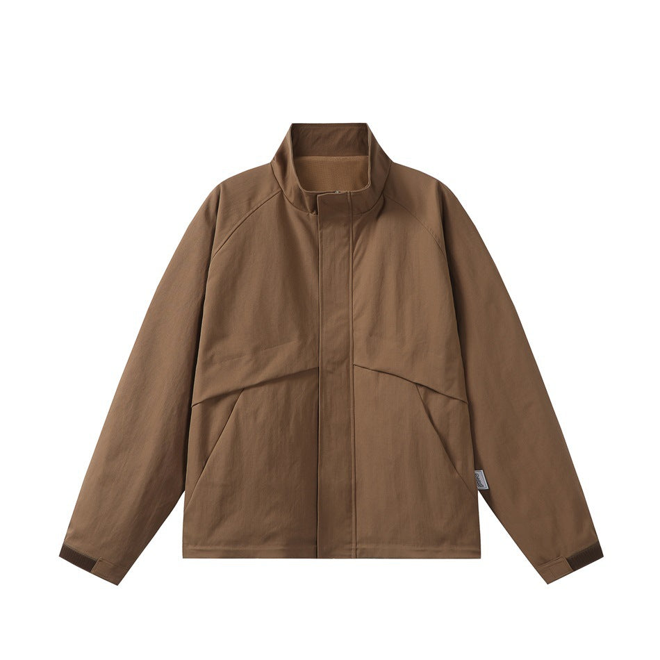 Brown stand-collar jacket, front flat lay, covered placket, raglan sleeves, angled seams and dark cuff tabs