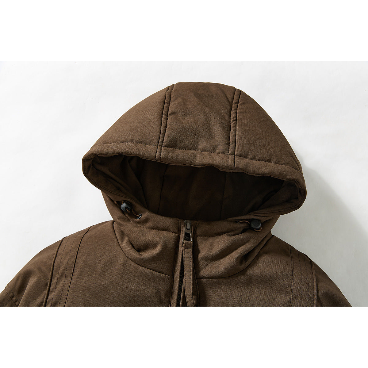 Close-up of a brown jacket’s hood, drawcord toggles, and upper front zipper.