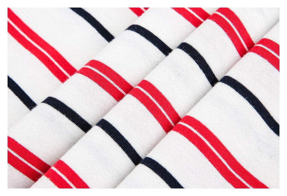 Close-up of white shirt fabric with repeating red and navy stripes.