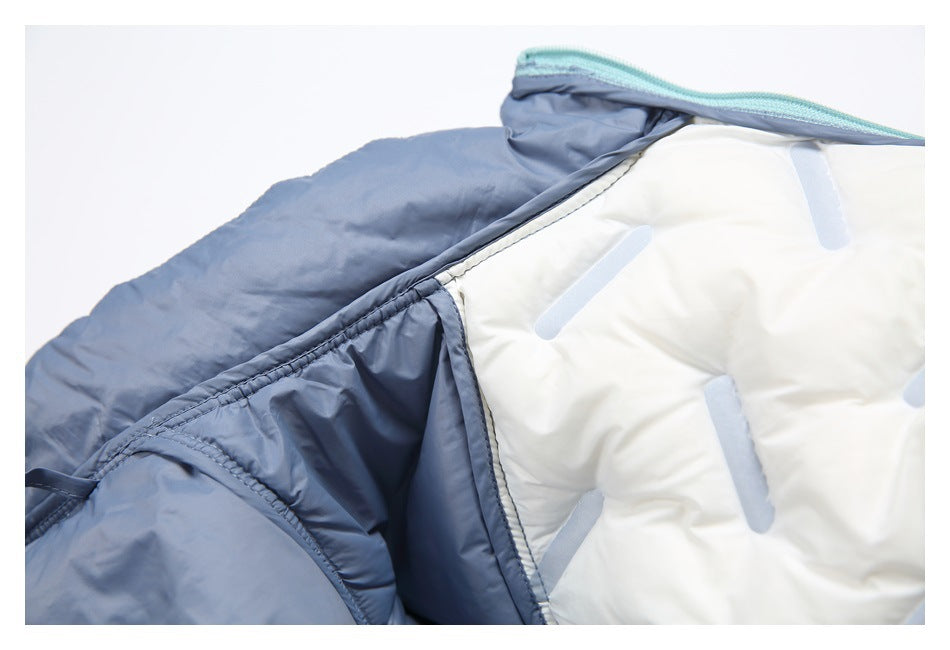 Close-up of a blue padded jacket opened to show its white lining and stitched interior seams.