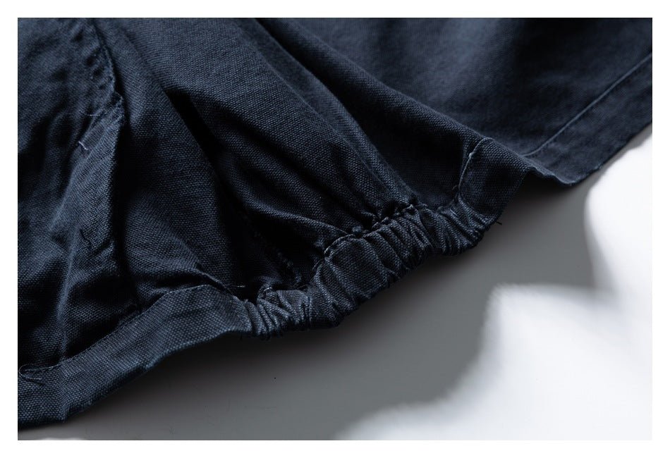 Close-up showing gathered elastic stitching along the edge of a dark navy garment.