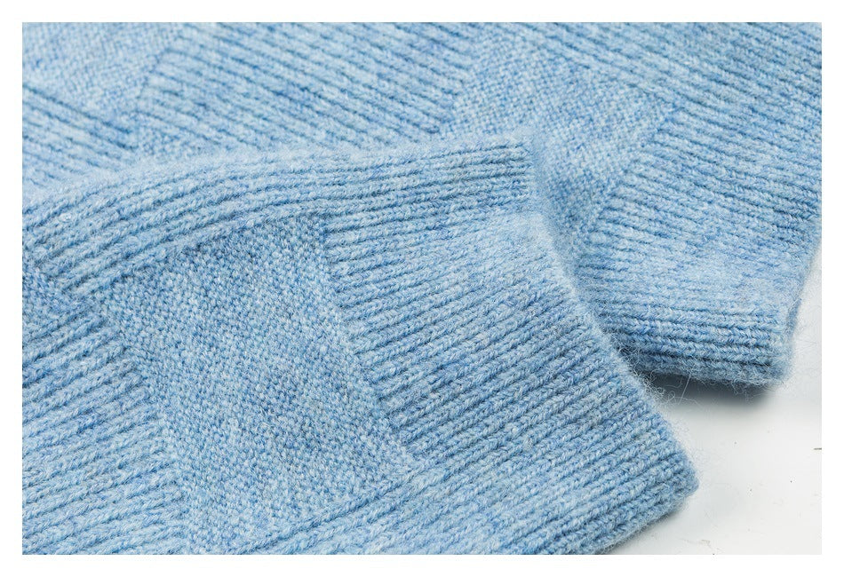 Close-up of light blue knit cardigan fabric and wide ribbed cuff and hem edges.