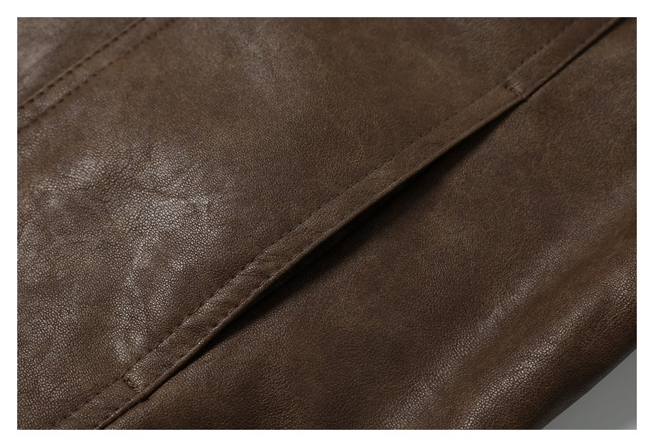 Close-up of a brown pebbled garment surface with a diagonal stitched seam.