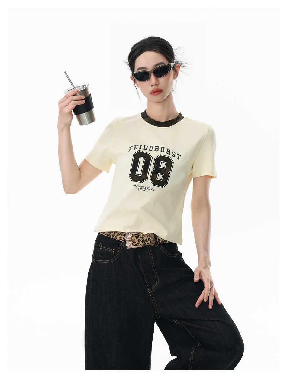 Close-up of model in beige short-sleeve 08 graphic tee with camo collar, holding a tumbler