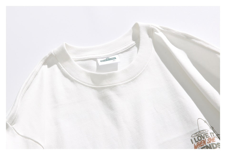 Close-up of the white T-shirt's crew neckline, shoulder seam, inside label marked “Made in China,” and partial chest graphic.