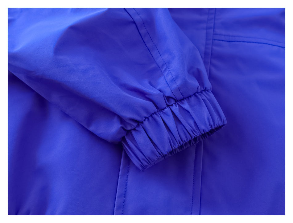 Close-up of a vivid blue sleeve with a gathered elastic cuff and visible stitching.