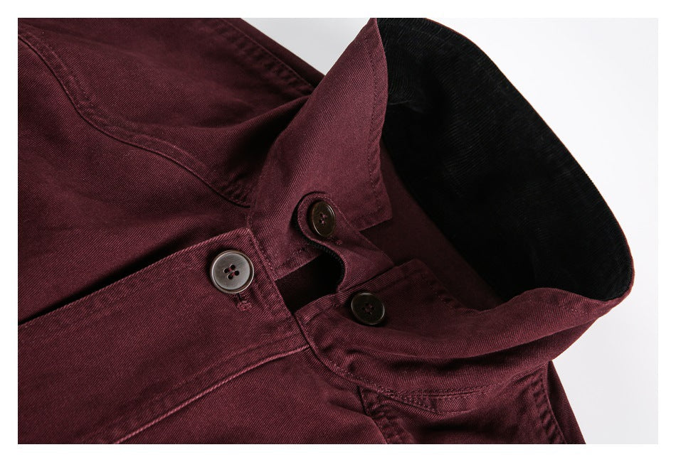 Close-up of a burgundy jacket collar, black underside, and front buttons.