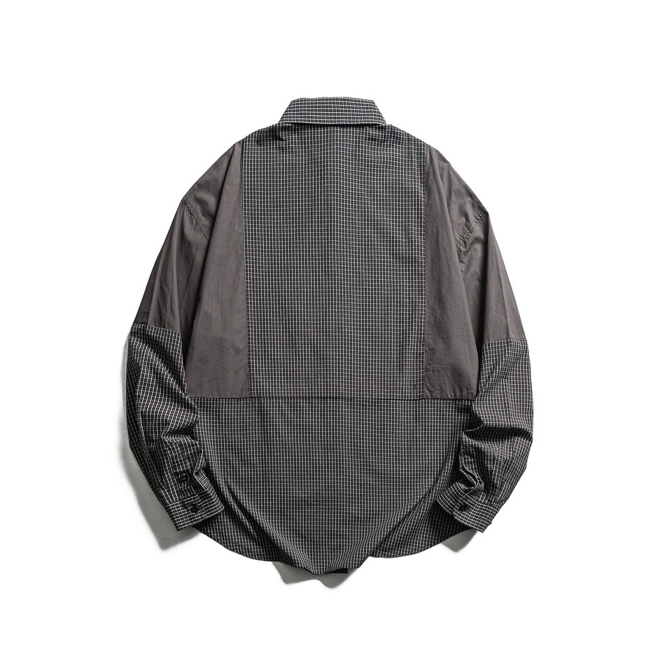 Back view of a gray shirt with a checked center and lower panel, solid sleeves, and checked cuffs.