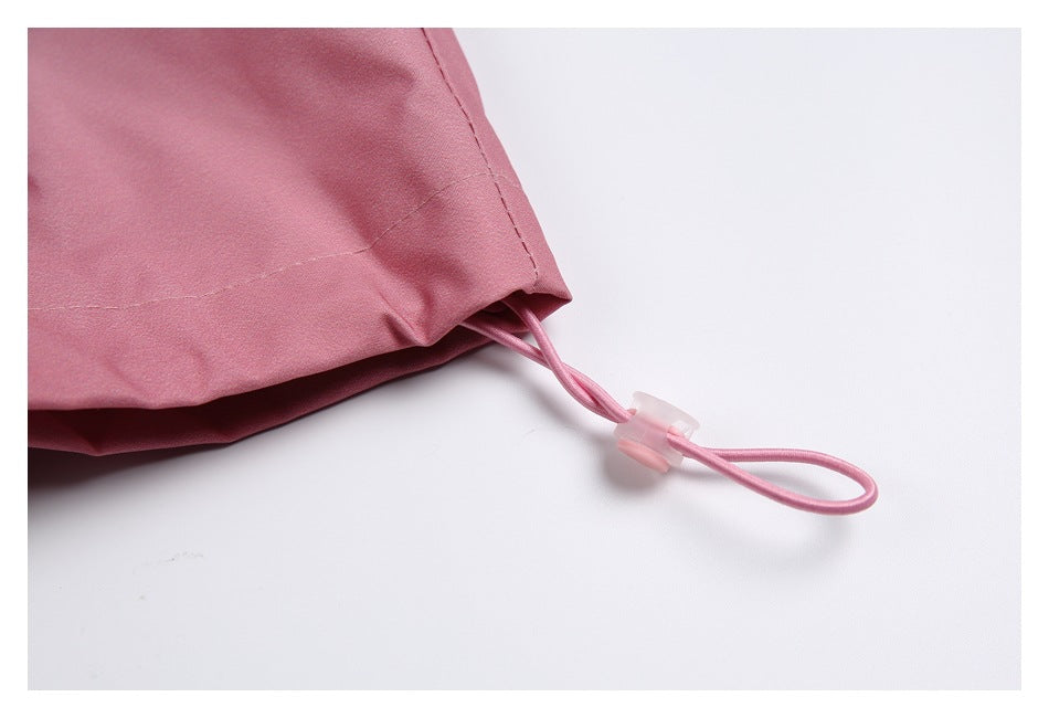 Close-up of a dusty pink hem with an elastic drawcord loop and translucent adjuster.