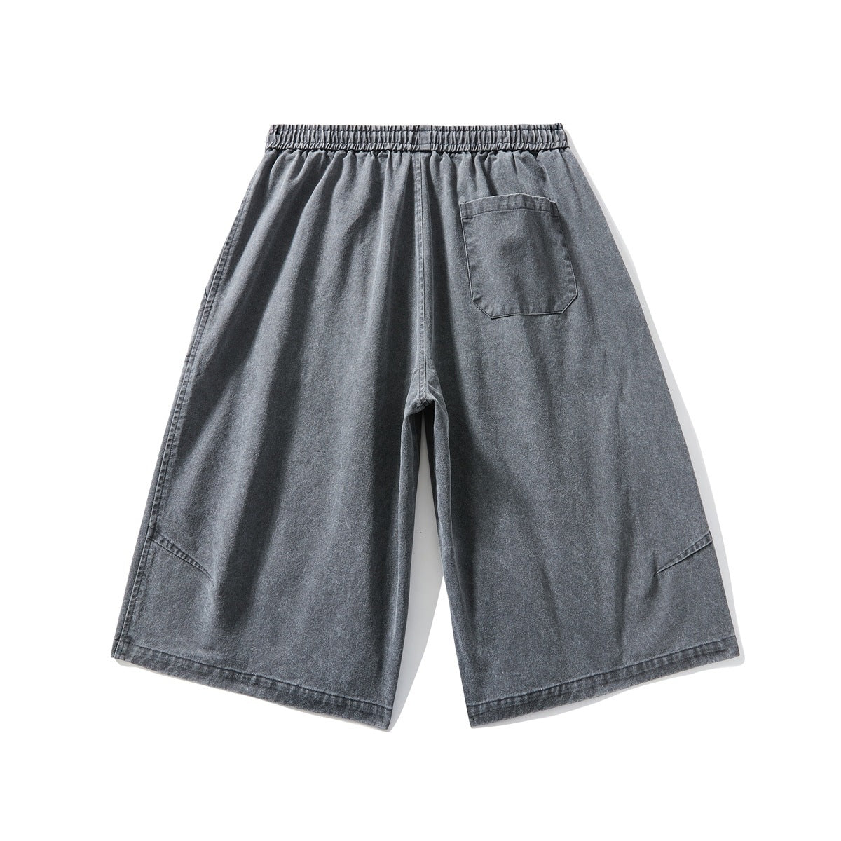 Back view of washed charcoal gray wide-leg shorts with an elastic waistband and a single patch pocket.
