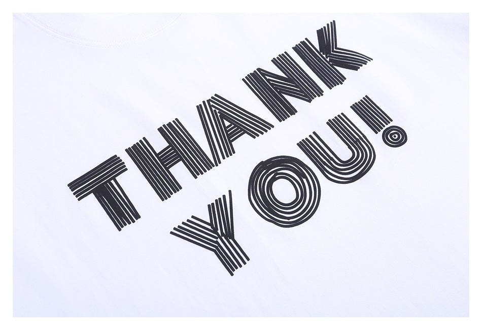 Close-up of a white T-shirt printed with bold black striped lettering reading “THANK YOU!”
