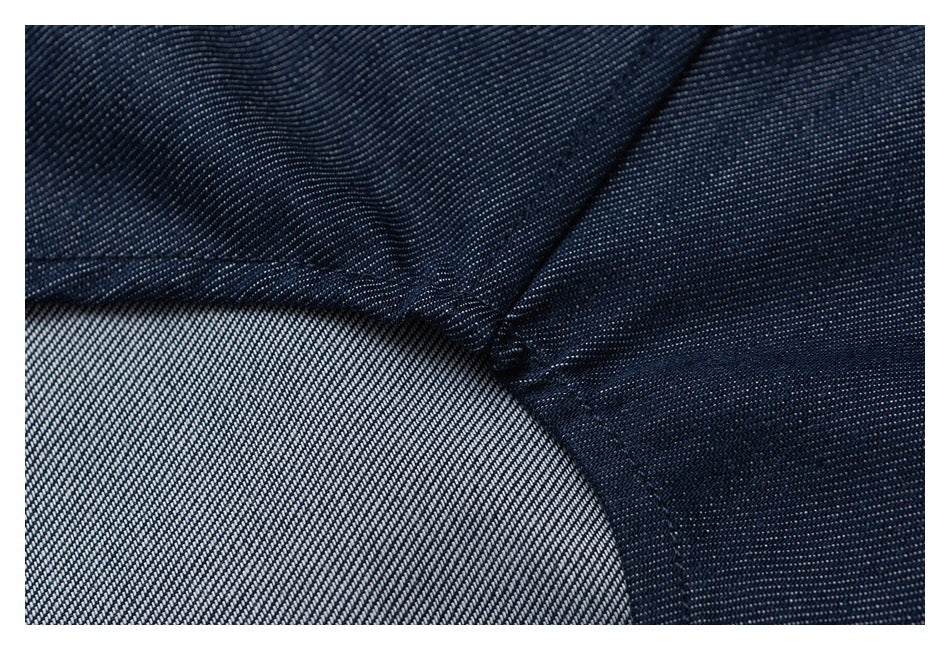 Close-up of dark navy fabric and a curved seam, with the lighter reverse side visible.