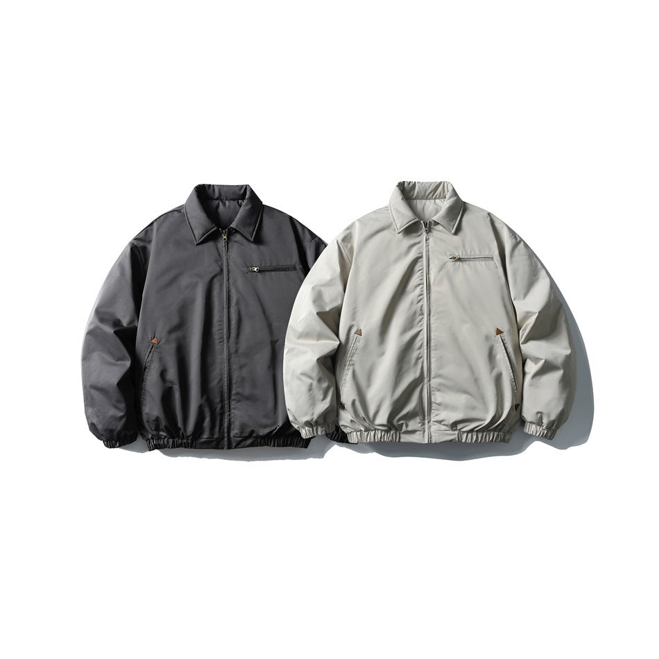 Two front-facing zip jackets, one charcoal gray and one light gray, with collars and elastic cuffs and hems.
