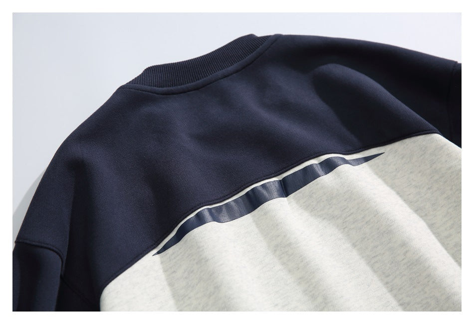 Close-up of the sweatshirt's navy upper back panel and light gray heather lower panel with a narrow navy stripe.