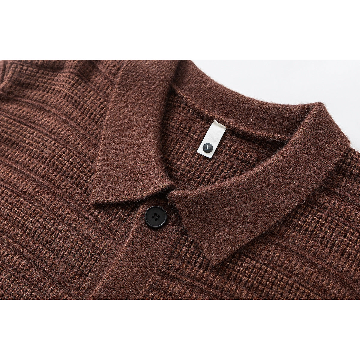 Close-up of a brown knit cardigan's pointed collar, black button, and small L size tag.