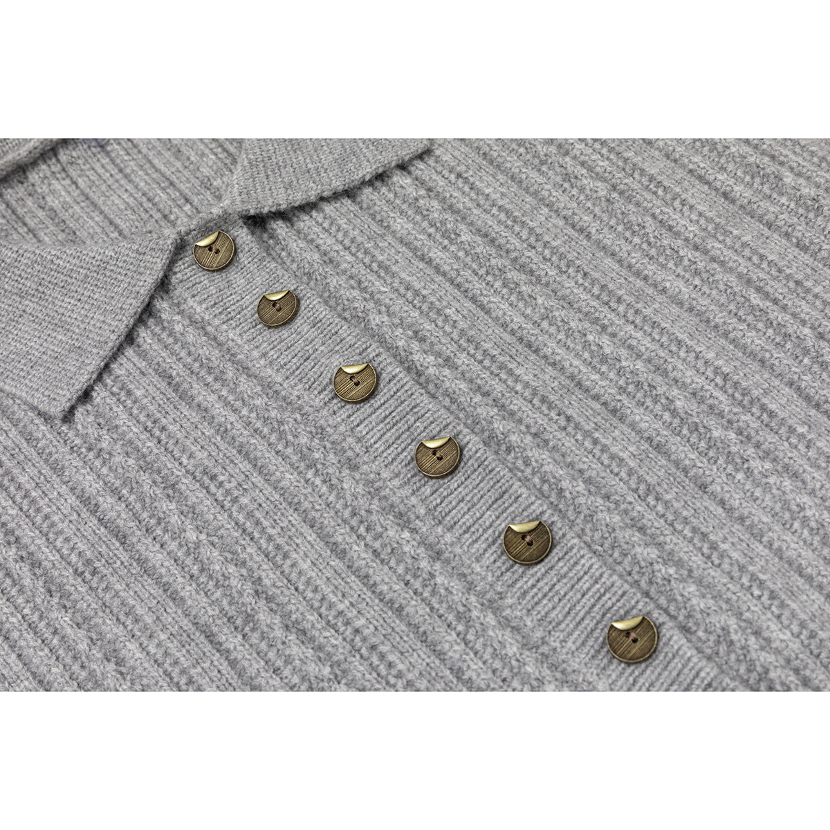Close-up of the gray rib-knit sweater's front placket with several brown buttons.