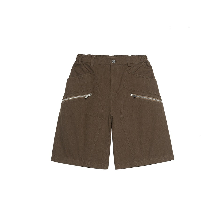Brown knee-length shorts, front flat lay, with elastic waistband, button, angled pockets and silver zippers