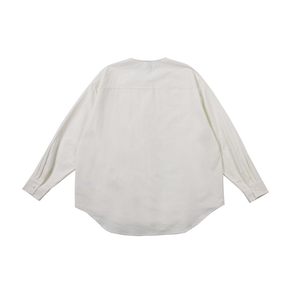 Back view of an off-white long-sleeved shirt with a curved hem and a horizontal yoke seam.