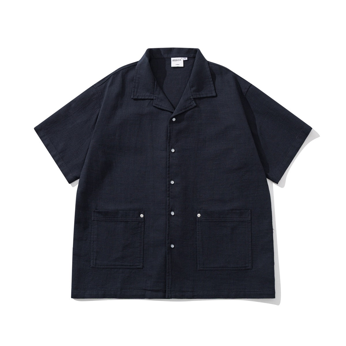 Navy short-sleeve camp-collar button shirt with two large patch pockets, flat lay front view