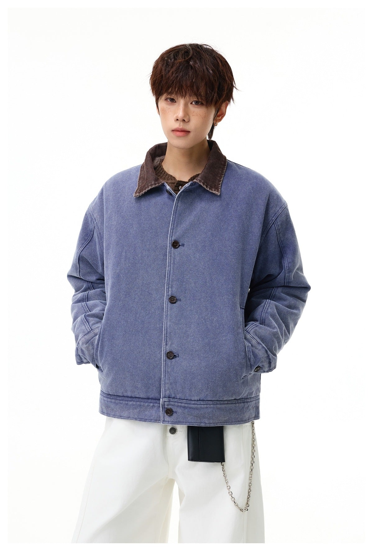Front view of a model wearing a faded blue button-front jacket with a brown corduroy collar.
