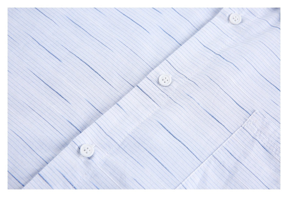 Close-up of white buttons, front placket, and fine blue stripes on the shirt.