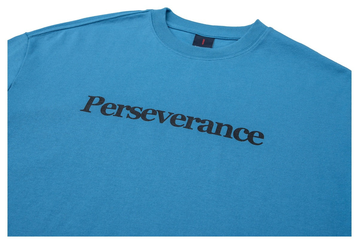 Close-up of the blue T-shirt front with black “Perseverance” lettering and a ribbed crew neck.