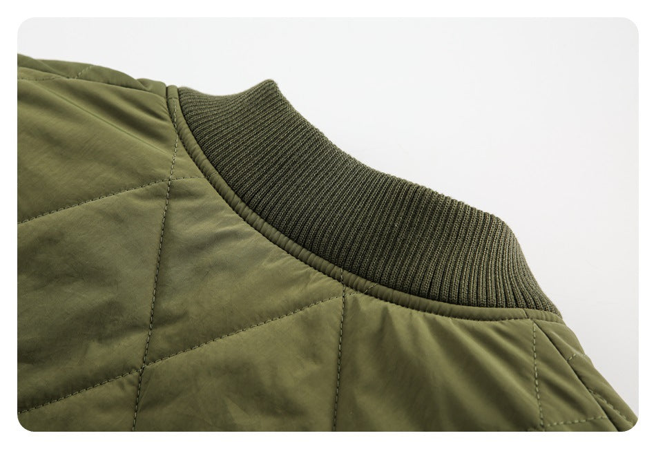 Close-up of a dark olive ribbed collar against an olive quilted jacket body.