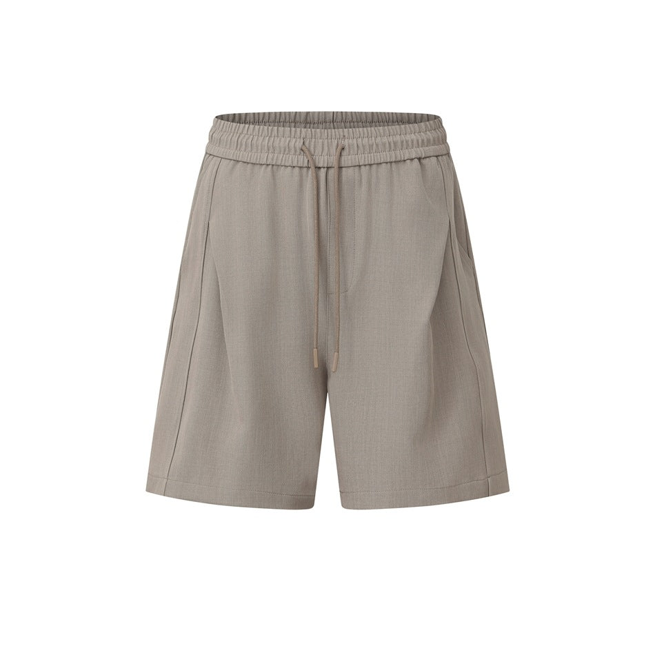 Taupe khaki drawstring shorts with elastic waistband and front pleat seams, flat front view