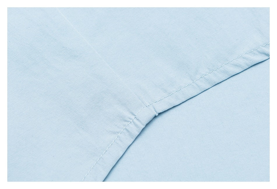 Close-up of light blue fabric with a curved, neatly stitched seam.