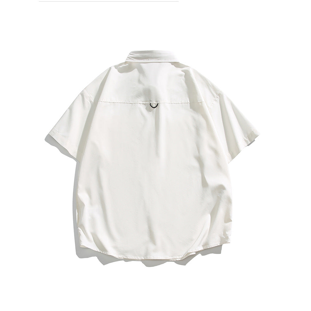 Back view of a white short-sleeve collared shirt laid flat, with a small loop below the yoke.