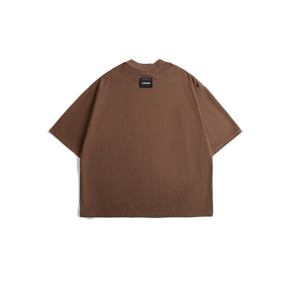 Back view of a brown oversized short-sleeve crew-neck T-shirt with a small black label at the upper back.