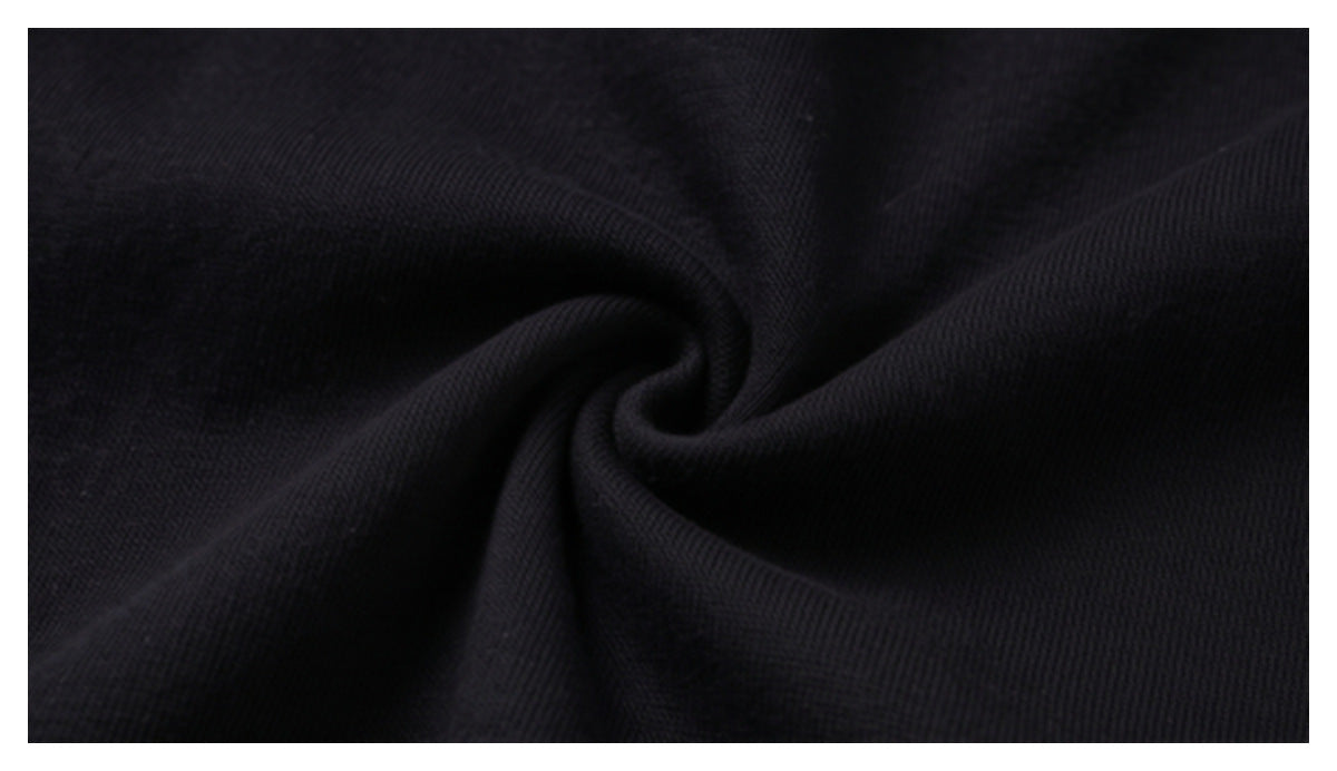 Close-up of black fabric gathered into a swirl, showing its fine knit texture.